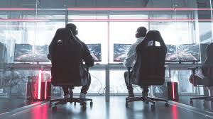 A professional esports team communicating strategy while sitting at their gaming setups during a tournament